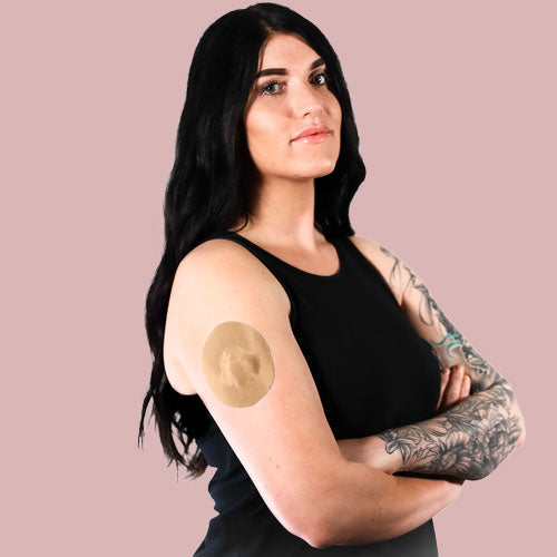 Woman wearing a Skin Grip patch on her Medtronic sensor